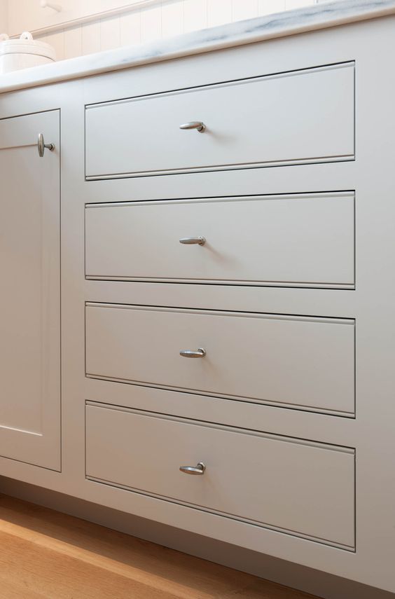Framed style cabinets in a Charleston, SC kitchen, featuring classic white doors and drawers with elegant hardware