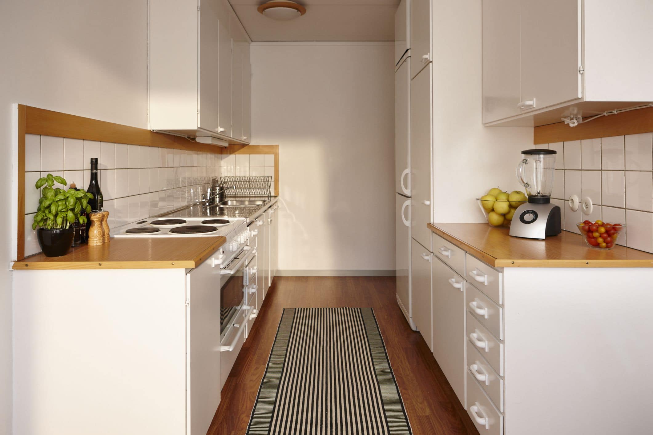 Galley kitchen layout in Charleston, SC, showcasing a narrow workspace with cabinets and appliances aligned along two parallel walls for efficient cooking and food preparation.