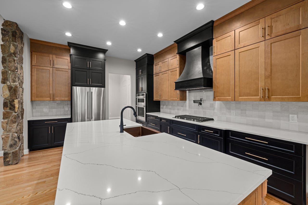 Modern kitchen featuring dark wood cabinets and premium finishes