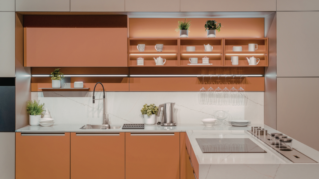 Minimalist frameless kitchen cabinets in a warm terracotta finish from Southern Cabinets.